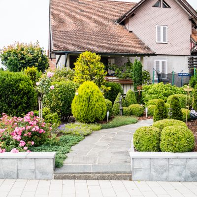 House front yard with flowers and trees in Vaduz, Lichtenstein